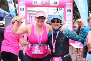 Women celebrating at the end of triathlon pink